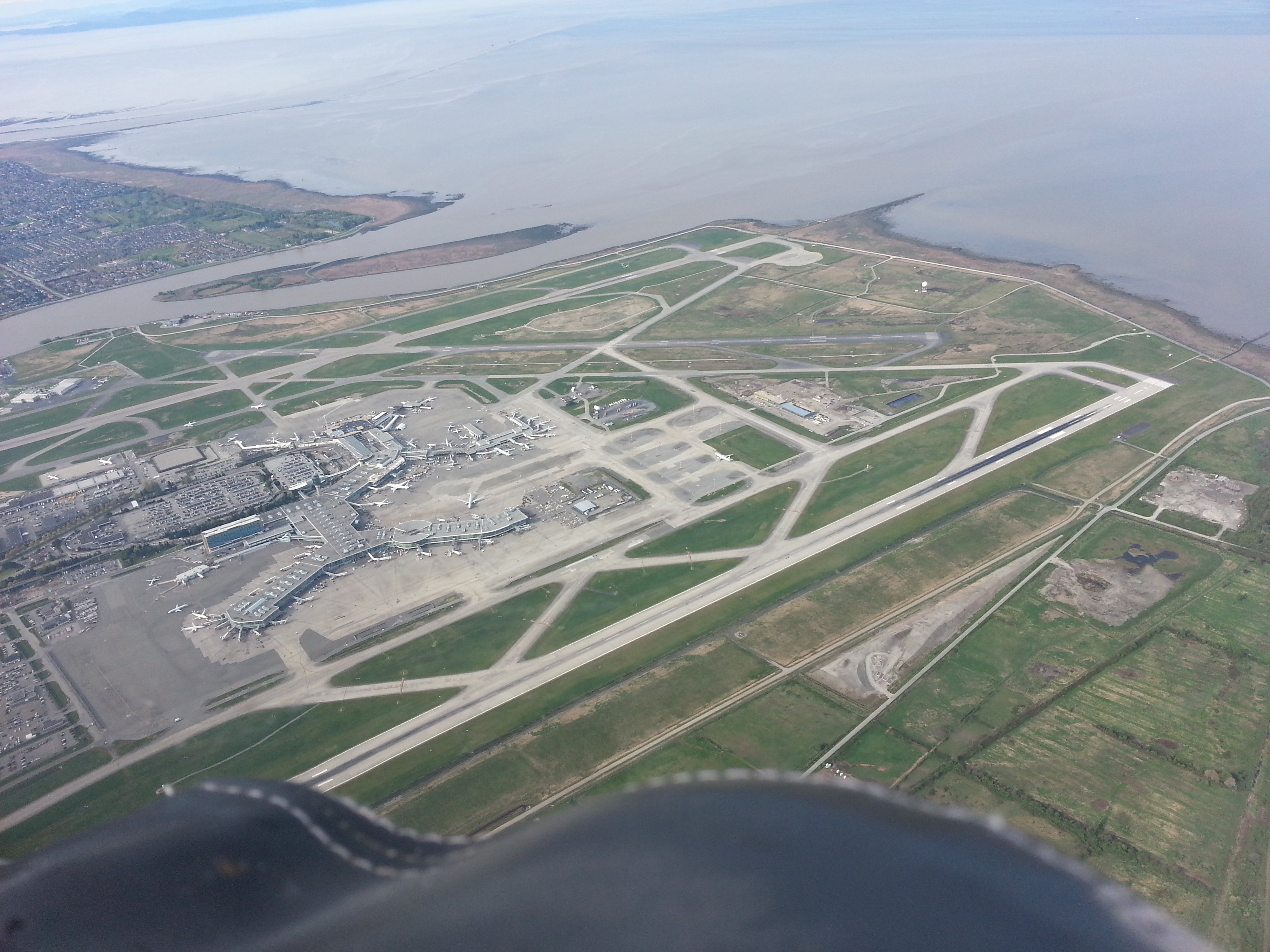 Over top of YVR, vectored to overfly the thresholds of 26L and 26R