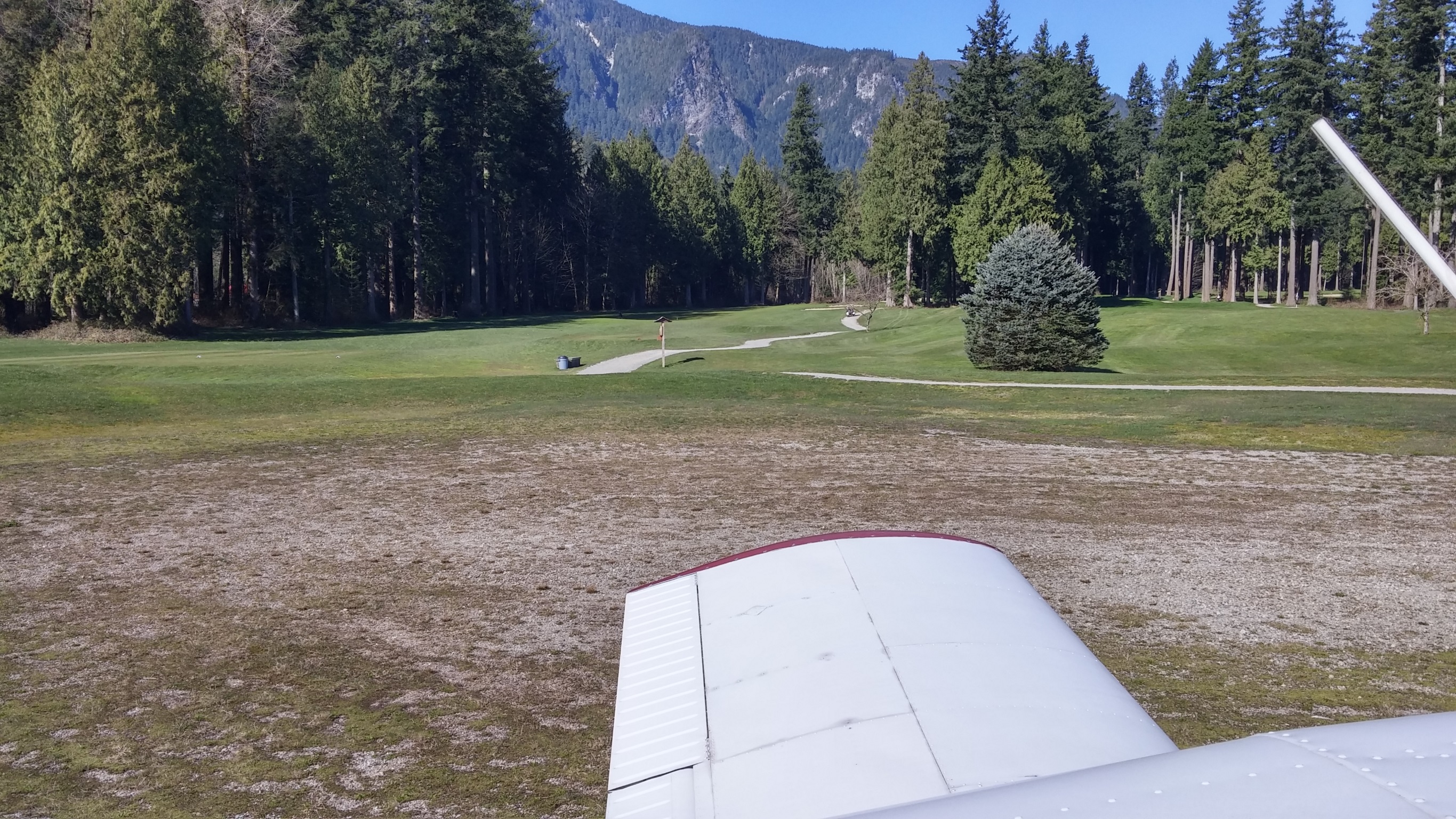 View over the left wing, looking down one of the fairways at the golf course